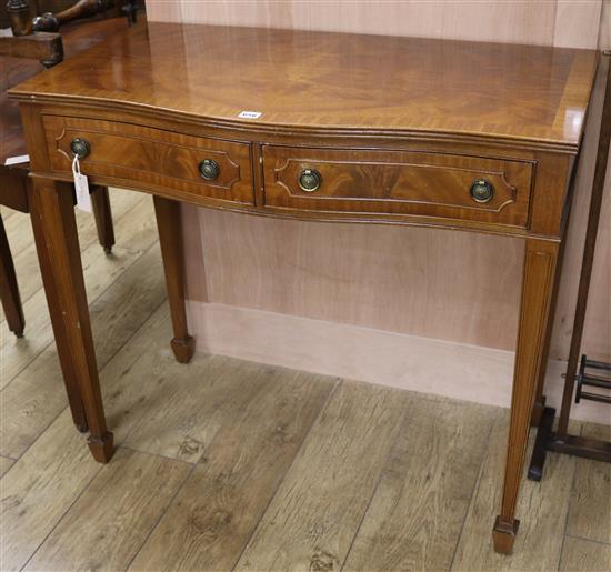 A reproduction serpentine side table W.95cm